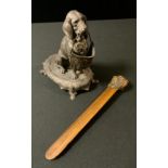 A late 19th century French spelter pen holder, modelled with a seated Bloodhound, shaped oval