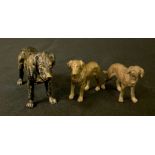 An Austrian patinated bronze model as a black Labrador Retriever , 6cm high, c.1920; two others