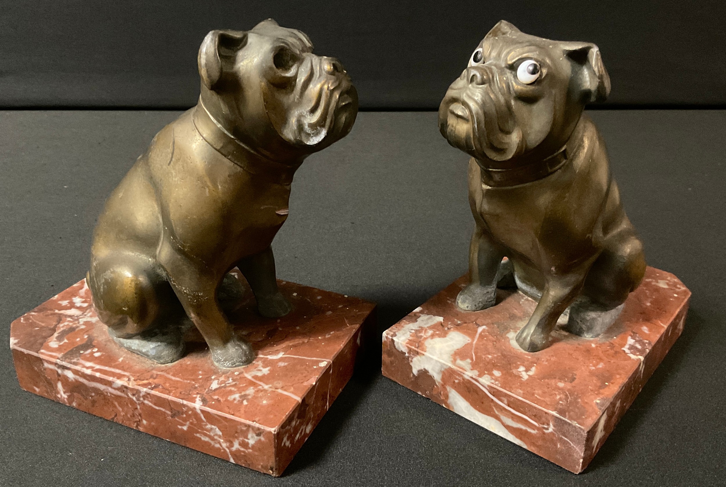 A pair of French spelter bookends, with seated Bulldogs, rouge marble bases, 13cm high