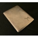 A George VI silver cigarette case, embossed with a terrier to the engine turned front, The