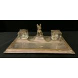 An early 20th century desk stand, of rectangular form, with two wells and French Bulldog, 31cm wide,