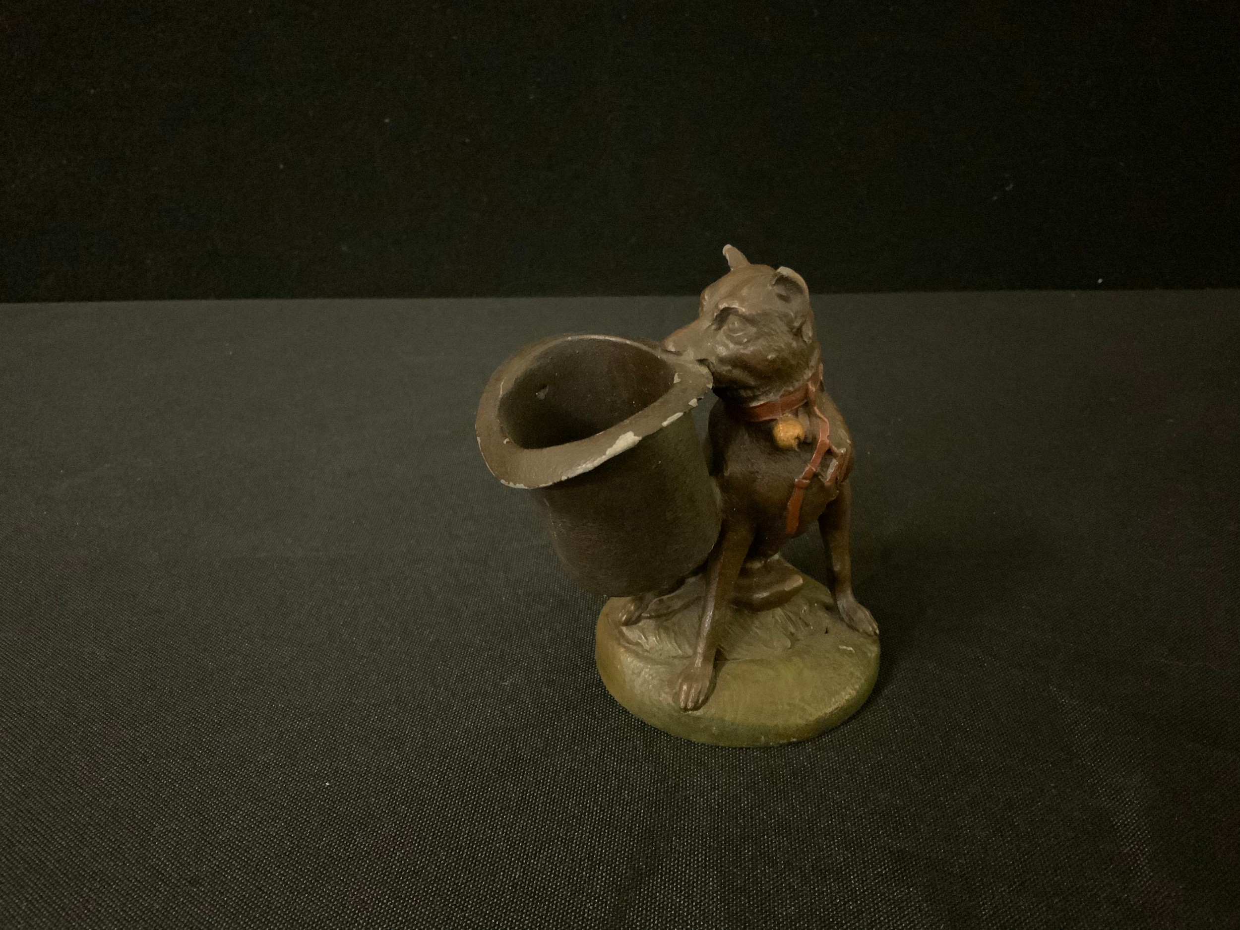 A 19th century French spelter novelty toothpick holder, of a dog holding a large top hat, 10cm high,