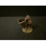 A 19th century French spelter novelty toothpick holder, of a dog holding a large top hat, 10cm high,