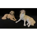 A pair of German bisque models, of St Bernards, reclining, 15cm wide, c.1910