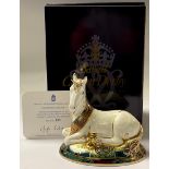 A Royal Crown Derby paperweight, New Millennium Unicorn, limited edition, 855/2,000, 14cm long, gold