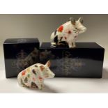 A Royal Crown Derby paperweight, Pig Money Box, gold stopper, 12cm, boxed; another, Sitting Pig,