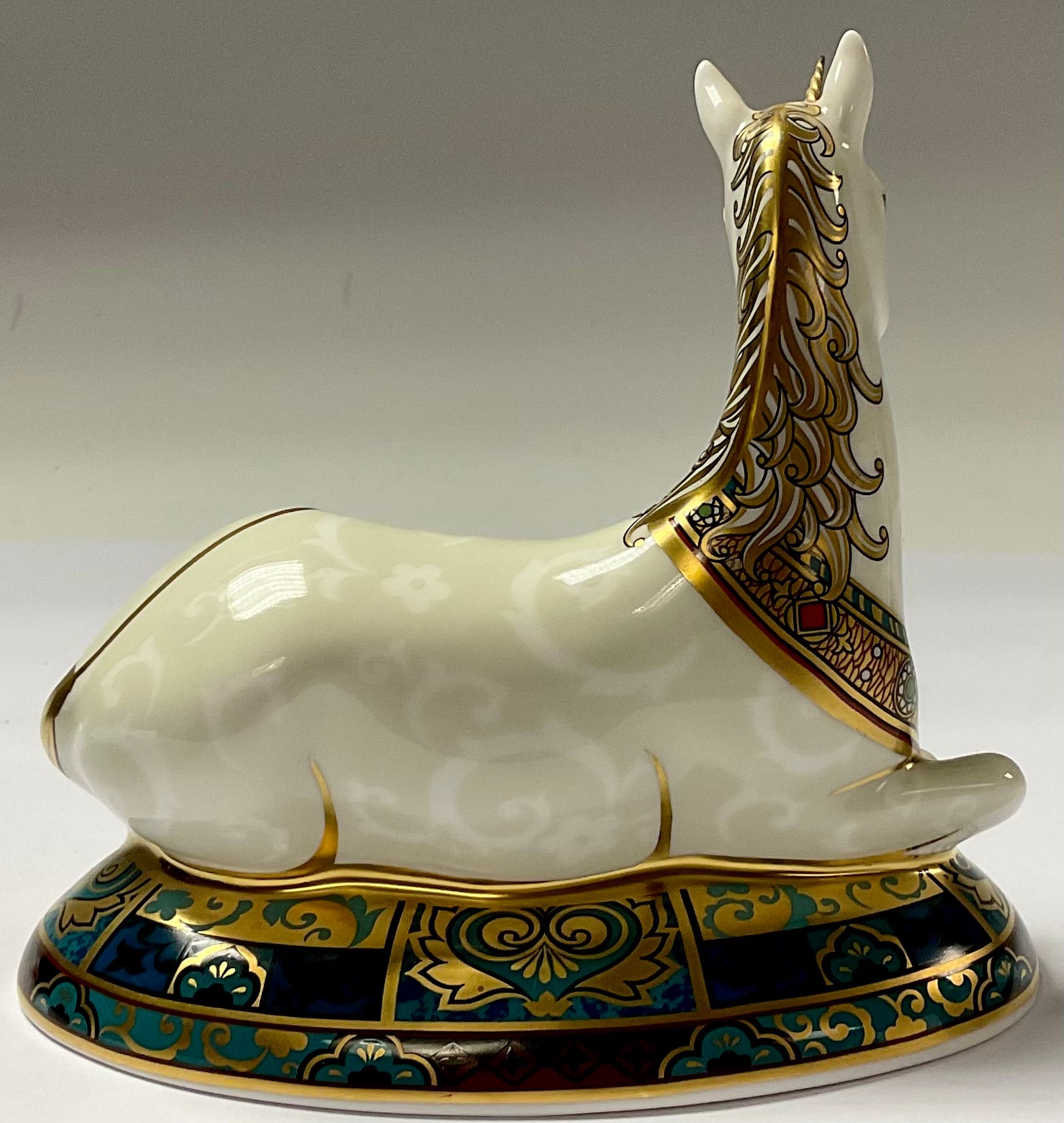 A Royal Crown Derby paperweight, New Millennium Unicorn, limited edition, 855/2,000, 14cm long, gold - Image 3 of 3