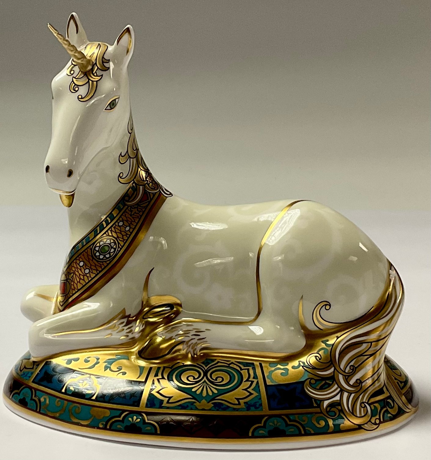 A Royal Crown Derby paperweight, New Millennium Unicorn, limited edition, 855/2,000, 14cm long, gold - Image 2 of 3