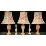 A set of three alabaster slender ovoid table lamps, octagonal bases, the hexagonal famille rose