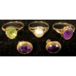 A 9ct gold amethyst ring, size N/O, 2.3g; a pair of 9ct gold amethyst earrings, 2g; a 9ct gold