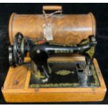 An early 20th century Singer hand cranked sewing machine, serial number F8709108