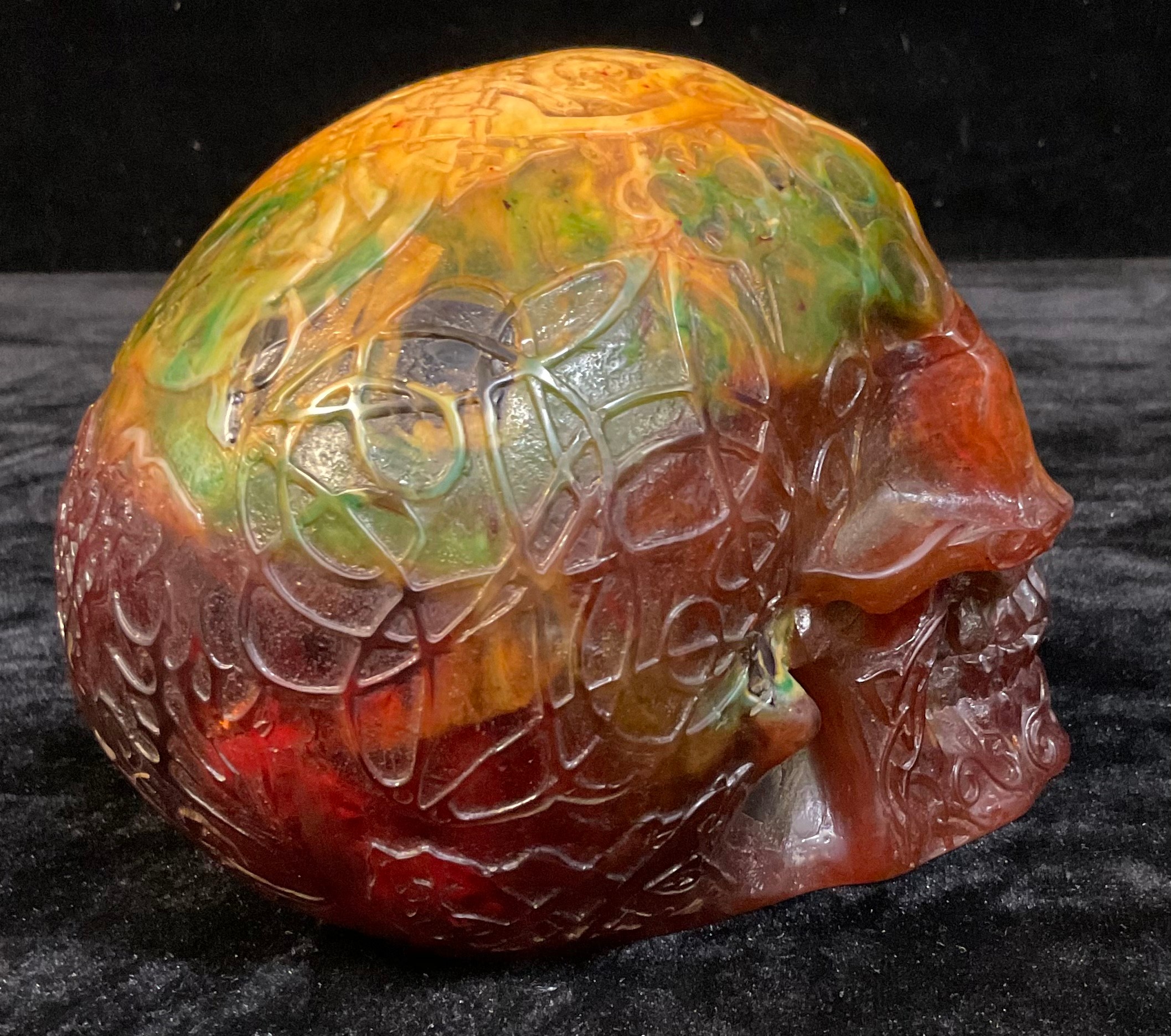 An amber coloured resin skull, cast with Celtic style scrolling decoration, 13cm high - Image 3 of 3