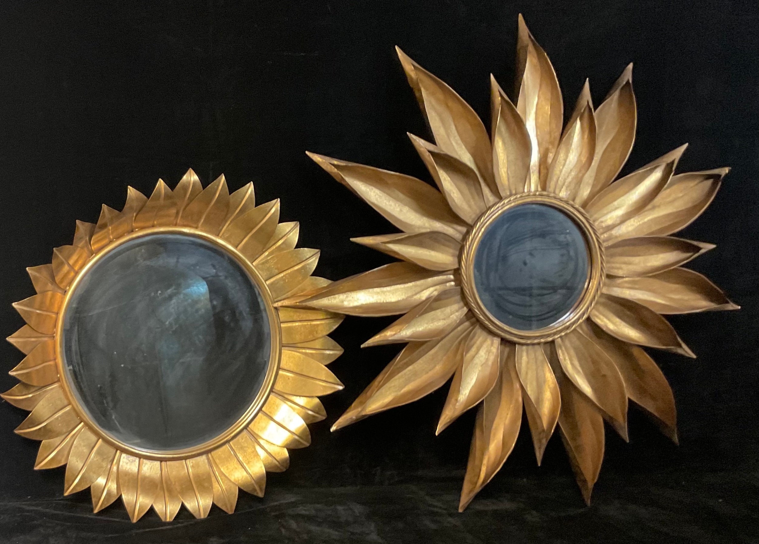 Interior Decoration - a gilt metal wall mirror, as a stylised flowerhead, circular bevelled plate,