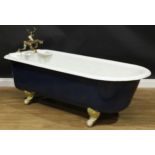 An early to mid-20th century cast iron roll top bath, ball and claw feet, 58cm high excluding