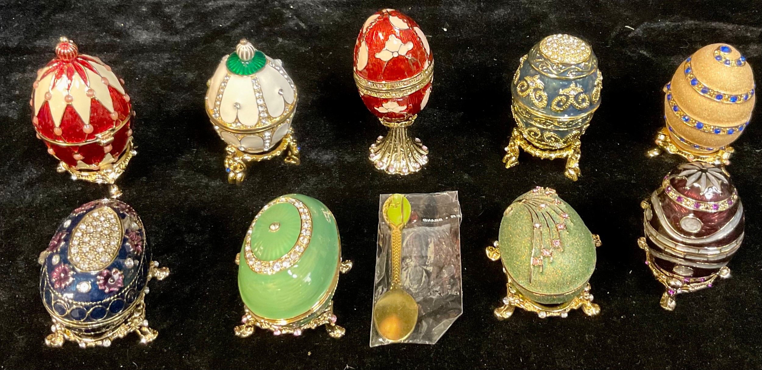 A set of nine Atlas Editions reproduction Fabergé Eggs on stands, including Lilac Flowers,