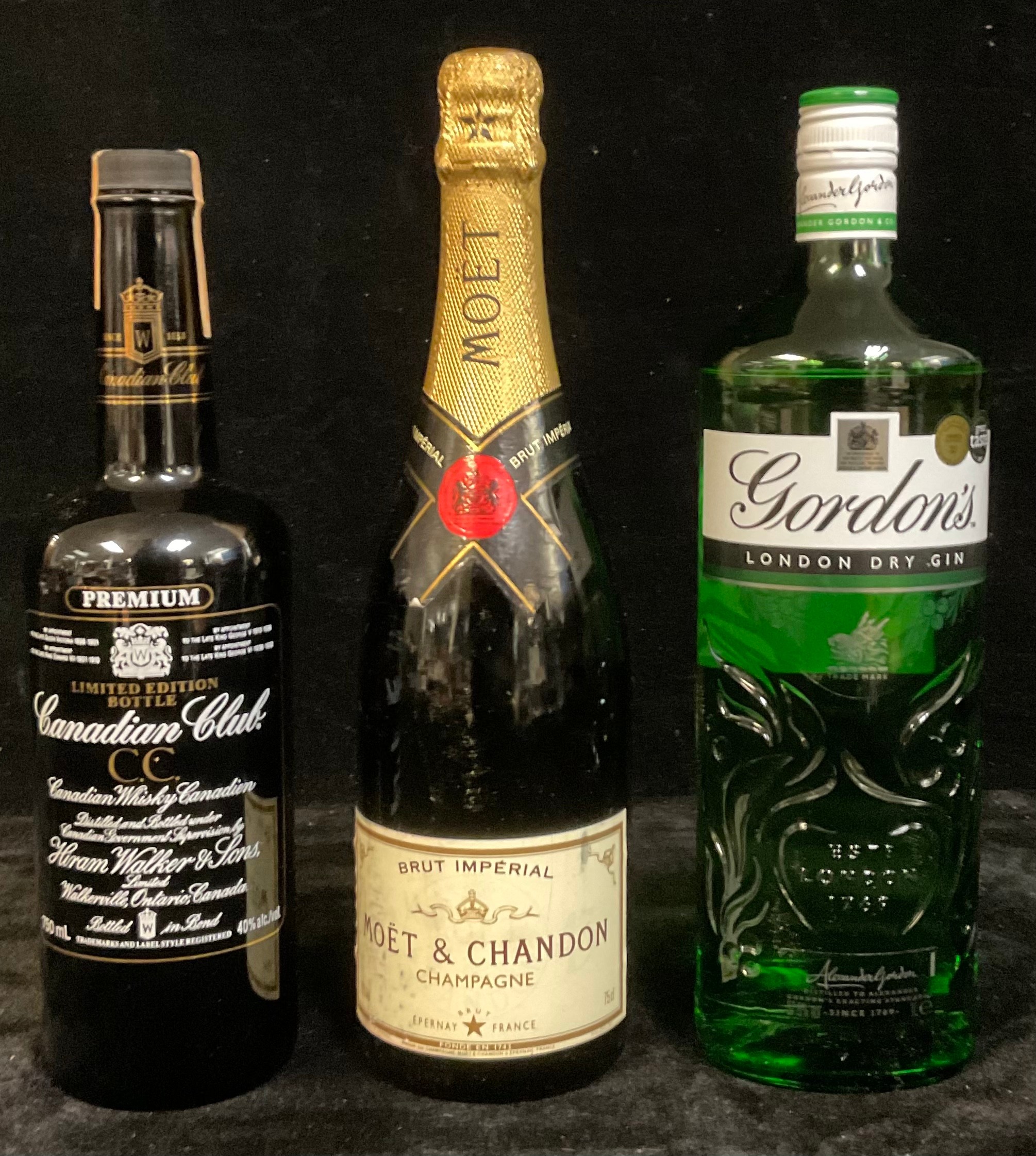 A bottle of Moet & Chandon Champagne, 75cl; a bottle of Gordon's London Dry Gin, 1L; a bottle of