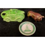 A Sadler Art Deco racing car teapot; a lustre bull; a Green Goddess advertising dish (3)