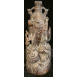A Chinese carved hardwood figure of a elder, sceptre and peach in his hands, a dragon at his feet,