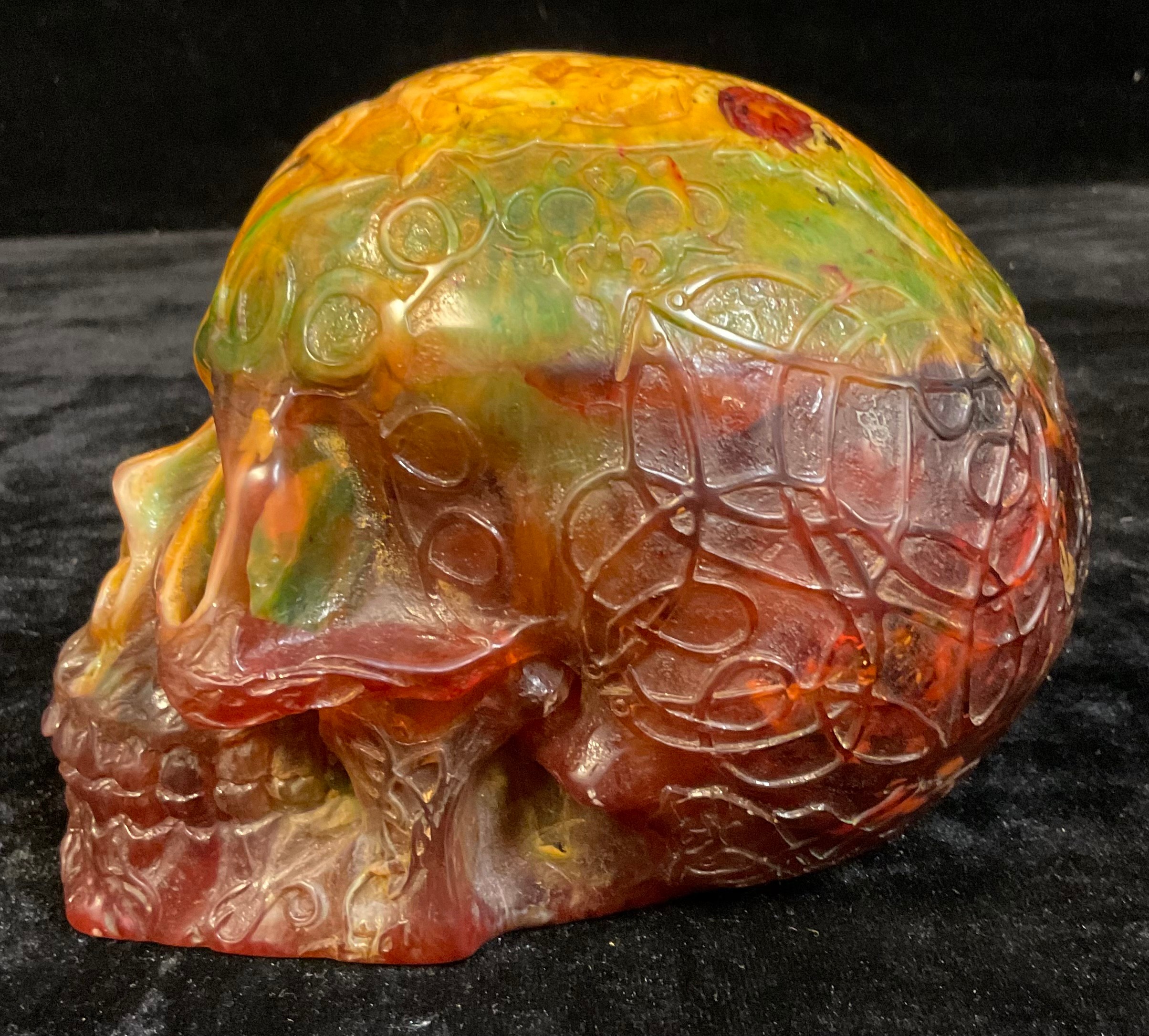 An amber coloured resin skull, cast with Celtic style scrolling decoration, 13cm high - Image 2 of 3