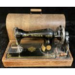 A Singer sewing machine, manual, wooden case