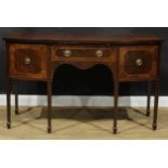 A George III Revival mahogany bowfront serving table or sideboard, oversailing top above a central