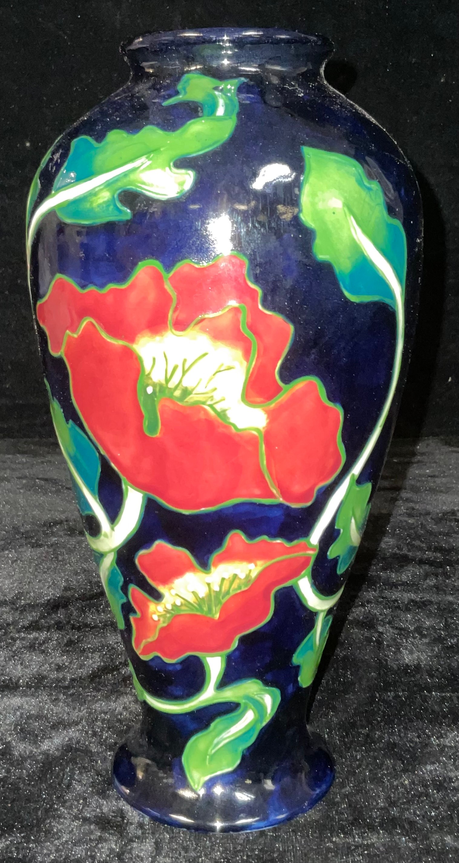 An Anne Rowe inverted baluster Poppy pattern tubelined vase, 27cm high