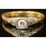An 18ct gold diamond ring, the central stone mounted in platinum, each shoulder set with three