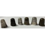 An Edwardian silver thimble, Birmingham 1902; other silver thimbles, etc (6)