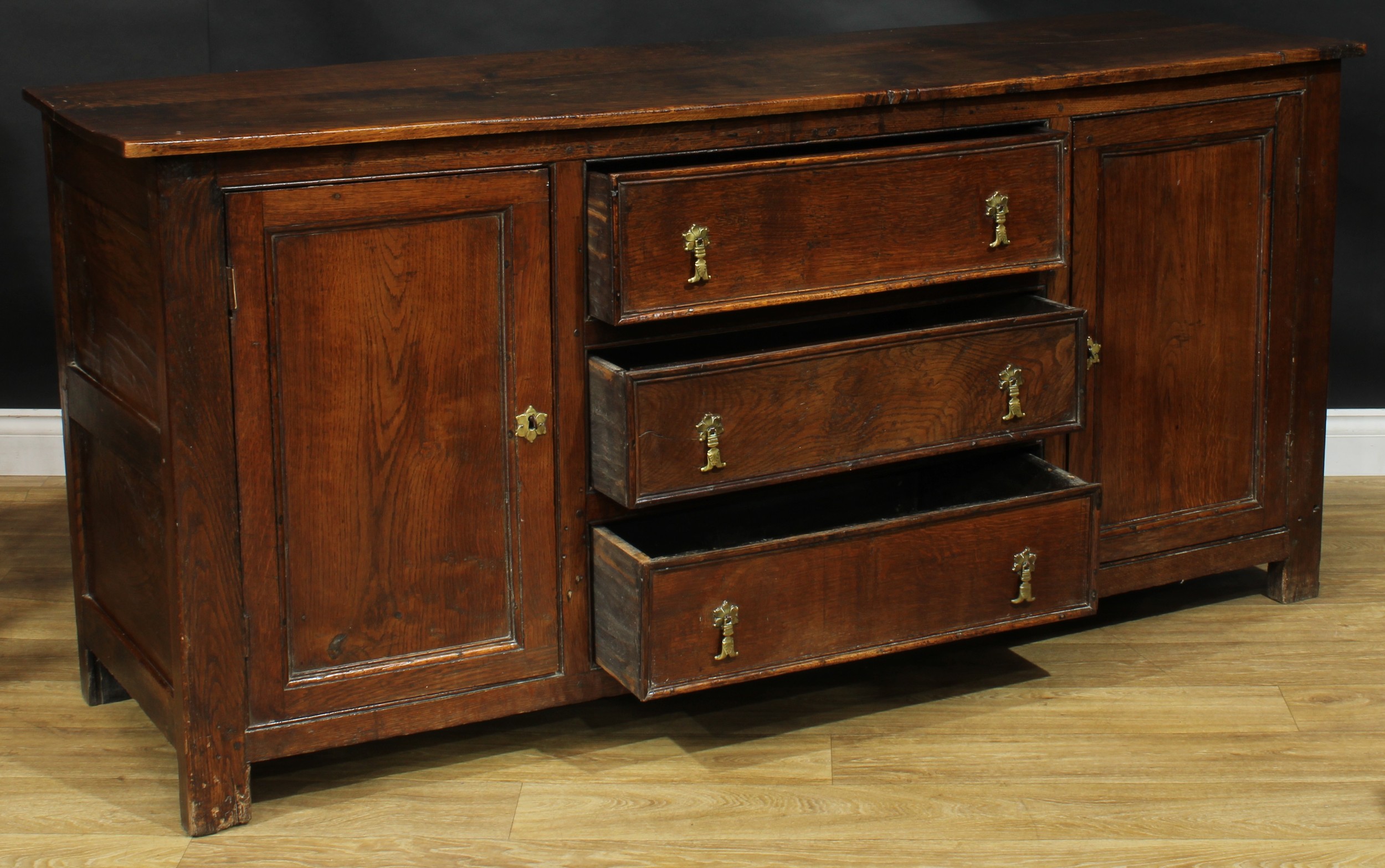 An oak low dresser, rectangular top above three drawers flanked by panel doors, each enclosing a - Image 4 of 4
