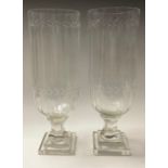 A large pair of reproduction Victorian style cut glass storm lamps, stepped bases, approx. 34cm high