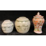 A 19th century Chinese ginger jar, 14.5cm high; another, 11.5cm; a baluster vase and cover (3)