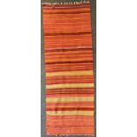 A Turkish woollen rug/runner, in bands of red, orange and ochre, 79cm wide, 208cm long