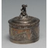 An early 20th century German silver cylindrical table snuff box, the domed cover surmounted with a