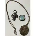 A Victorian oval silver locket; an enamel and silver locket; a cross (3)