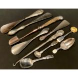 A George III caddy spoon as an acorn, stilton scoop, silver hafted shoe horns, etc