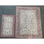 A rectangular Persian style rug or carpet, decorated with stylised flowerheads and foliage, in tones