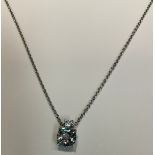 A silver and cubic zirconia pendant necklace, the large facet cut stone suspended from a smaller