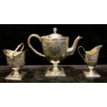 A silver plated three piece tea service, domed pedestal teapot, embossed with foliate scrolls,