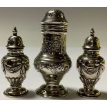 A pair of Edwardian silver baluster salt and pepper pots, embossed with ribbon tied swags, 7cm,