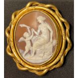 A 19th century pinchbeck shell cameo swivel broock, carved with Venus and Cupid, 8cm long