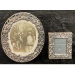 A small Edwardian silver easel photograph frame, Birmingham 1902; a Continental silver oval