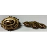 A Victorian gilt metal brooch; another (2)