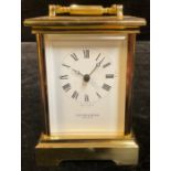 A Taylor & Bligh brass carriage timepiece, quartz movement, 17cm high over swing handle