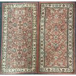 A rectangular Persian style woollen rug or carpet, decorated with stylised flowerheads and