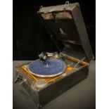 A Dulcetto portabe wind-up gramophone; a small selection of 78s