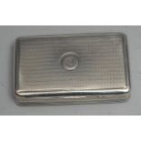 A George III silver rounded rectangular snuff box, engine turned overall, hinged cover, gilt