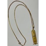 An Egyptian gold hieroglyphic pendant and chain, 7g