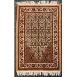 A Islamic woollen prayer mat, Saudi Arabia, geometric pattern in shades of red, green, black and