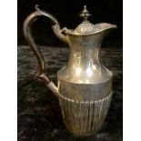 An Edwardian silver stop fluted hot water jug, domed hinged cover, ebonised finial, ebonised