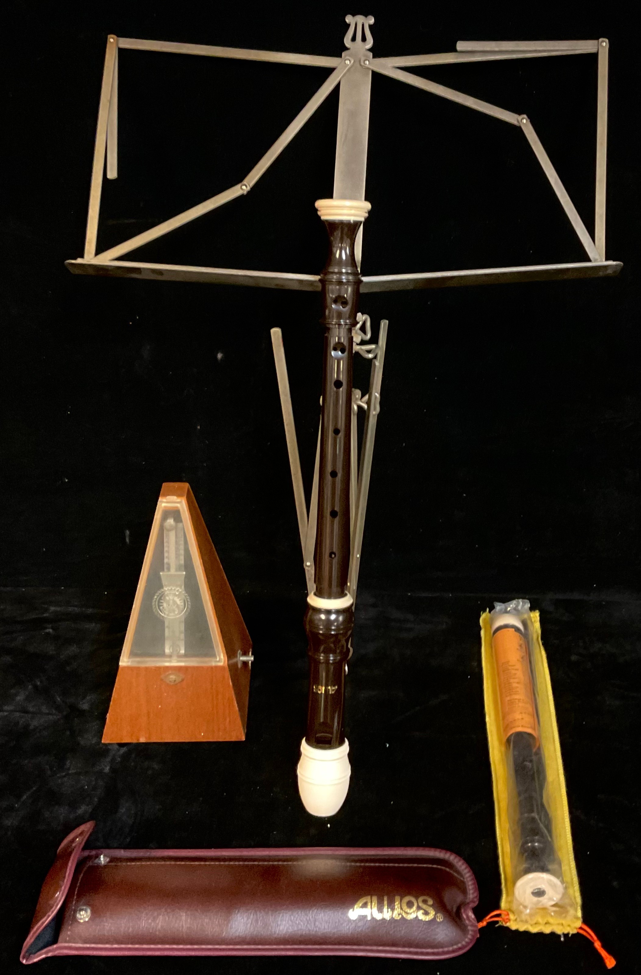 A metronome; two Aulos recorders and a folding music stand